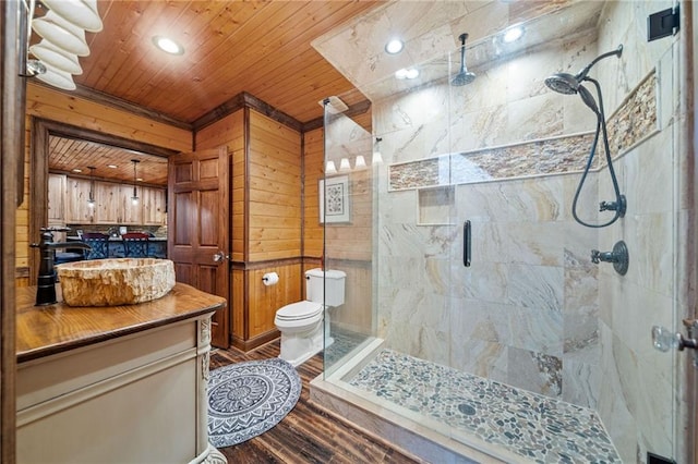 bathroom featuring wood ceiling, hardwood / wood-style flooring, a shower with door, wooden walls, and vanity