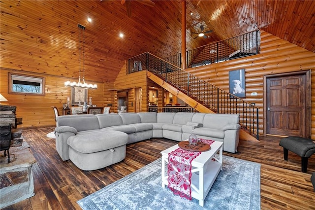 living room with hardwood / wood-style floors, wood ceiling, high vaulted ceiling, and log walls