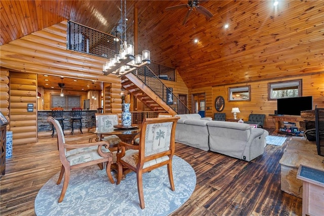 dining space with high vaulted ceiling, log walls, hardwood / wood-style floors, and wooden ceiling