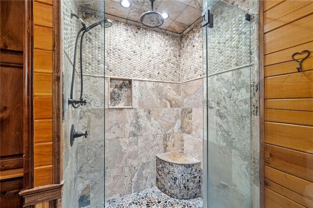 bathroom featuring a shower with shower door