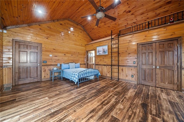 unfurnished bedroom with hardwood / wood-style flooring, lofted ceiling, wooden walls, and wooden ceiling