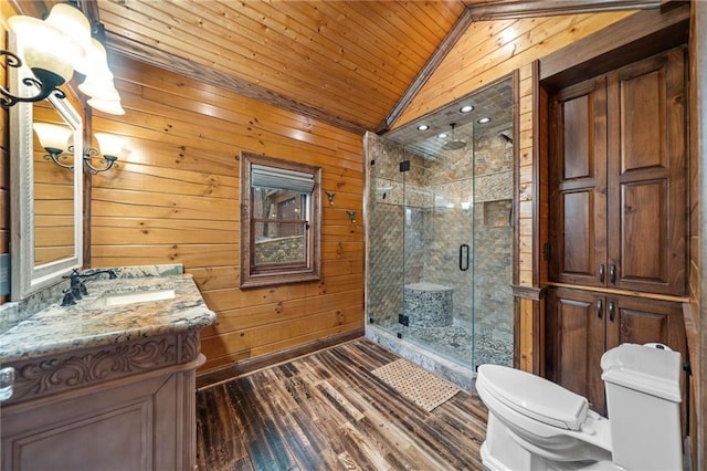 bathroom with lofted ceiling, toilet, a shower with shower door, wood walls, and vanity