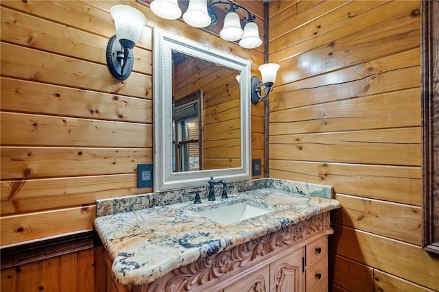 bathroom featuring vanity and wood walls