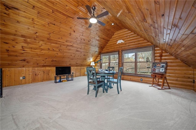 unfurnished dining area featuring lofted ceiling, wooden walls, wooden ceiling, and carpet