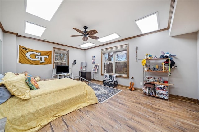 bedroom featuring hardwood / wood-style flooring, ceiling fan, and ornamental molding