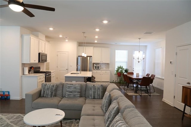 4734 Dewitt Dr, Duluth, GA 30097 - living area featuring a chandelier, dark wood finished floors, baseboards, and recessed lighting
