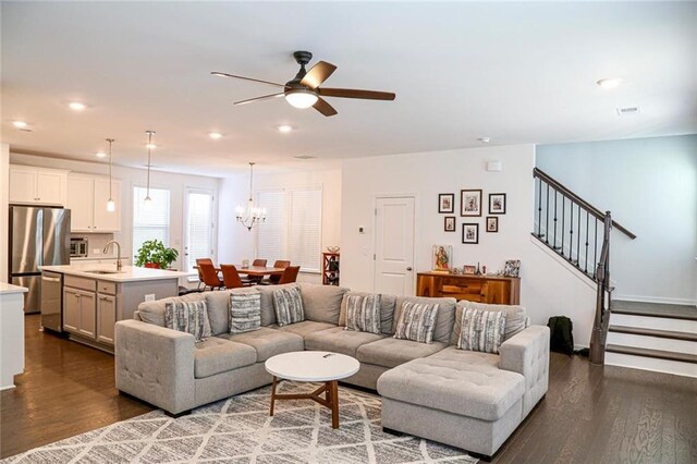 4734 Dewitt Dr, Duluth, GA 30097 - living area featuring dark wood-type flooring, a ceiling fan, stairway, a chandelier, and recessed lighting