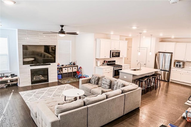 4734 Dewitt Dr, Duluth, GA 30097 - living room featuring dark wood-style floors, ceiling fan, recessed lighting, and a tiled fireplace