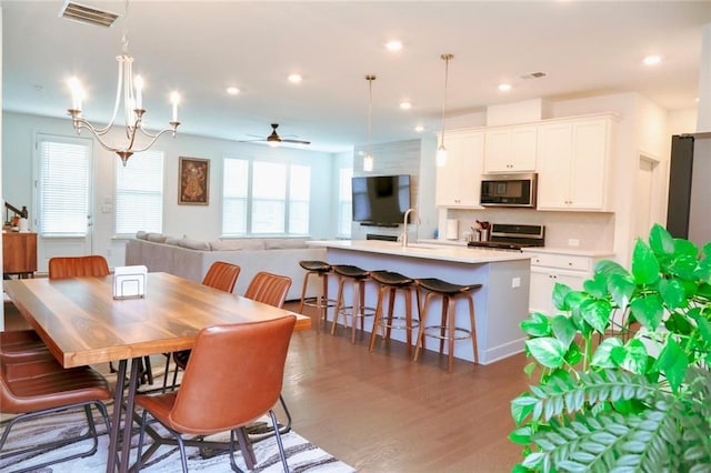 4734 Dewitt Dr, Duluth, GA 30097 - dining room with plenty of natural light, wood finished floors, recessed lighting, a ceiling fan, and a chandelier