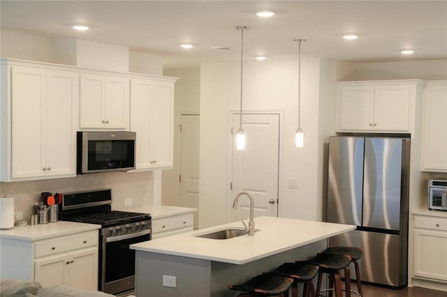 4734 Dewitt Dr, Duluth, GA 30097 - kitchen with stainless steel appliances, a sink, a breakfast bar, decorative backsplash, and white cabinets