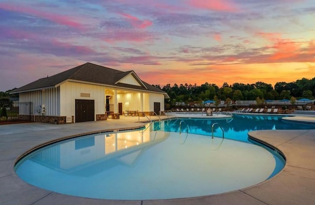 4734 Dewitt Dr, Duluth, GA 30097 - pool at dusk with a patio area, a community pool, and fence