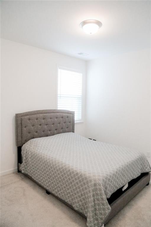 4734 Dewitt Dr, Duluth, GA 30097 - bedroom featuring light colored carpet and baseboards