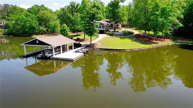 view of dock with a water view, a yard, and boat lift