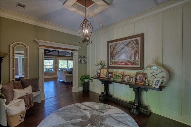 interior space with ornamental molding, a decorative wall, wood finished floors, and visible vents