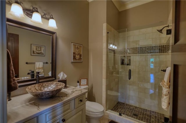 full bath with vanity, a shower stall, and toilet