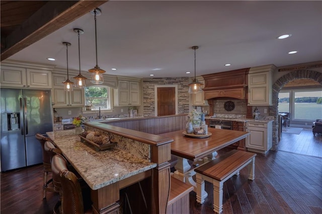 kitchen featuring decorative backsplash, premium range hood, dark wood-style floors, stainless steel fridge, and recessed lighting
