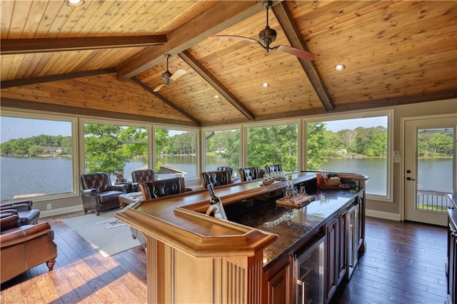 sunroom featuring hardwood / wood-style floors, beverage cooler, vaulted ceiling with beams, wood ceiling, and a bar