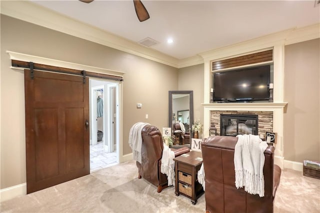 living area with light carpet, a stone fireplace, a ceiling fan, visible vents, and ornamental molding