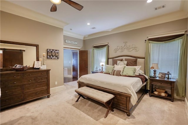 bedroom featuring light colored carpet, ceiling fan, visible vents, and ornamental molding