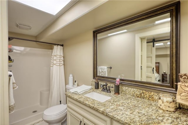 bathroom featuring vanity, toilet, visible vents, and a stall shower