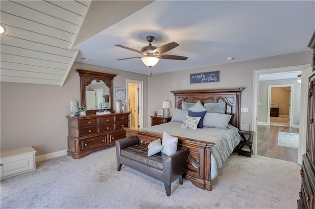 carpeted bedroom with baseboards, ceiling fan, and visible vents