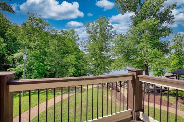 wooden terrace featuring a yard