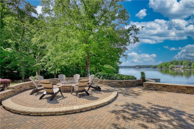view of patio featuring a water view and a fire pit