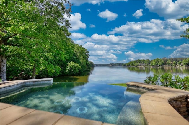 view of pool featuring a water view