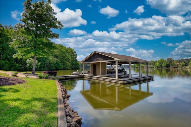 view of dock featuring a lawn, boat lift, and a water view