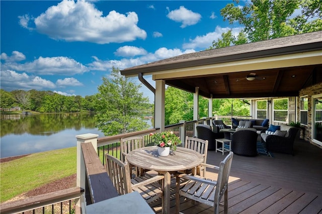 wooden terrace with a water view, a ceiling fan, an outdoor hangout area, and outdoor dining area