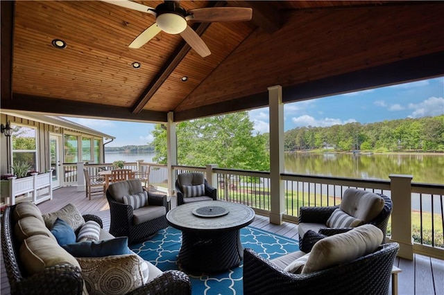 wooden terrace featuring an outdoor living space, french doors, a ceiling fan, a wooded view, and a water view