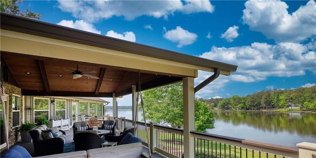 wooden deck featuring an outdoor living space, a water view, and a ceiling fan