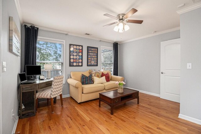 living area featuring baseboards, a ceiling fan, light wood-style flooring, and visible vents