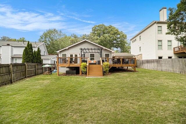 back of property featuring a lawn, a fenced backyard, and a deck