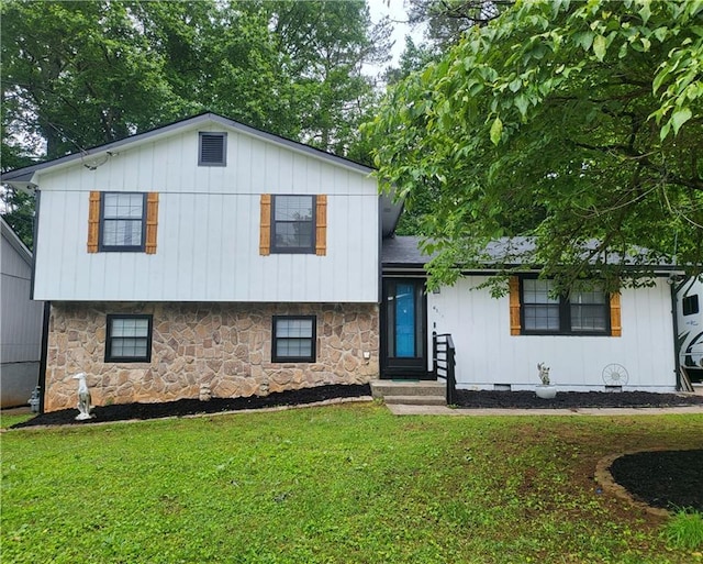 6118 Dana Ct, Lithonia, GA 30058 - split level home featuring stone siding, a front yard, and board and batten siding