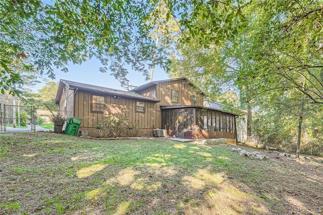 6118 Dana Ct, Lithonia, GA 30058 - back of property with board and batten siding, a gate, and a sunroom