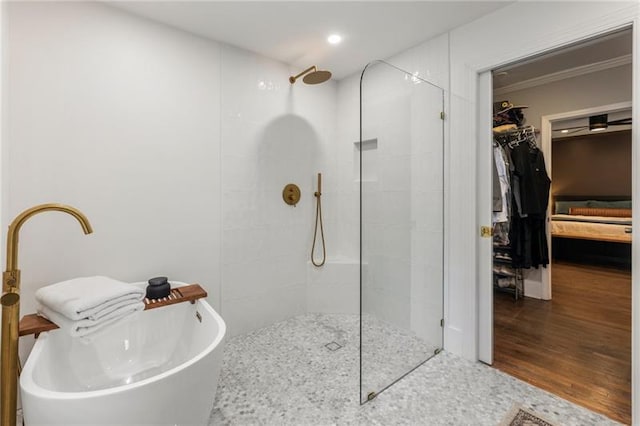 410 Wilkinson Dr SE, Atlanta, GA 30317 - bathroom with wood finished floors, a sink, a walk in closet, a walk in shower, and a freestanding tub