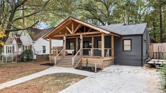 410 Wilkinson Dr SE, Atlanta, GA 30317 - view of front of house featuring a porch, fence, and a shingled roof