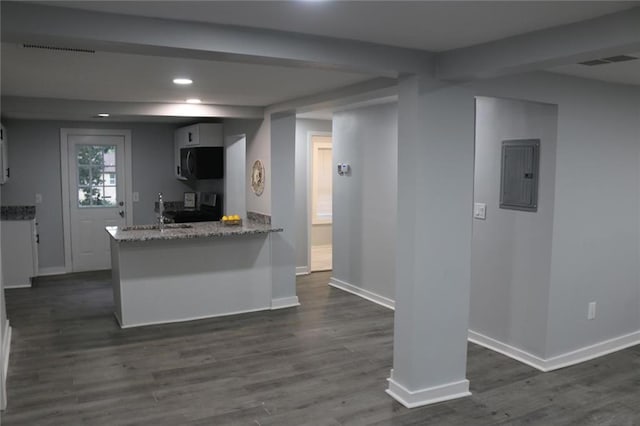 2040 Penelope St NW, Atlanta, GA 30314 - kitchen with electric panel, black microwave, stove, baseboards, and recessed lighting
