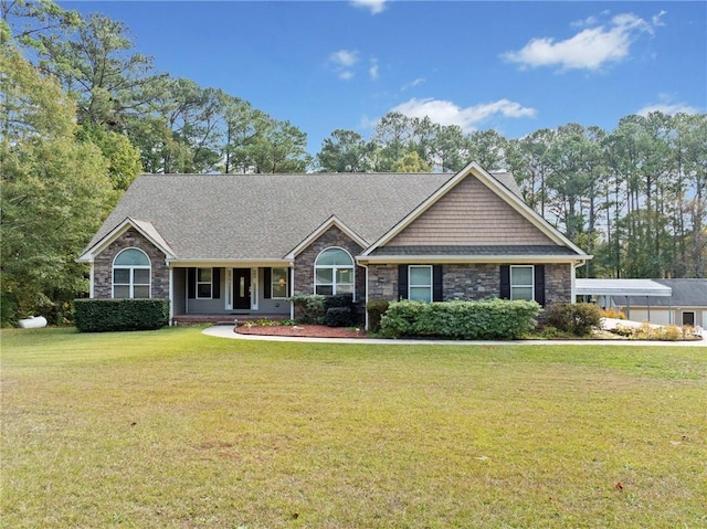 view of front facade featuring stone siding and a front lawn