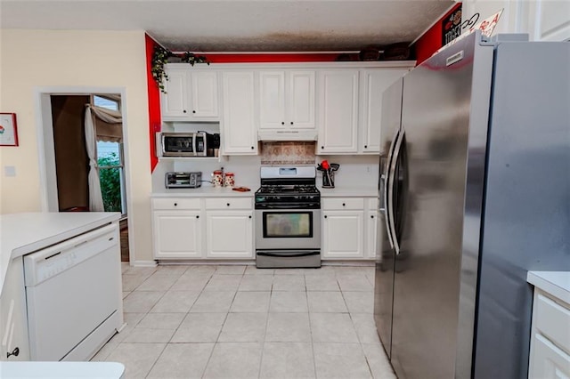 laundry area featuring washing machine and dryer, sink, and light tile patterned floors