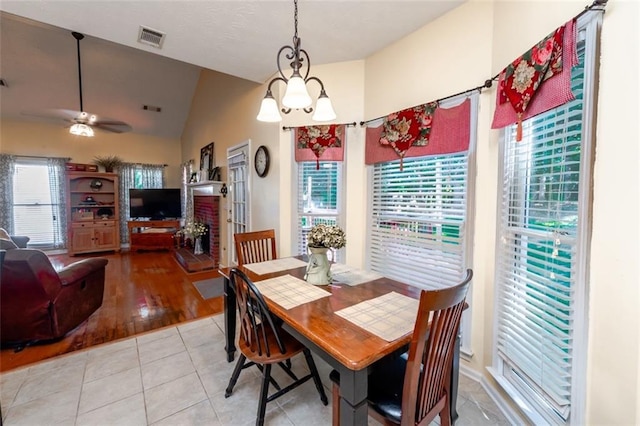 carpeted bedroom with a tray ceiling, multiple windows, ornamental molding, and ceiling fan