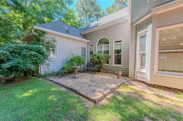 view of home's exterior featuring a garage and a lawn