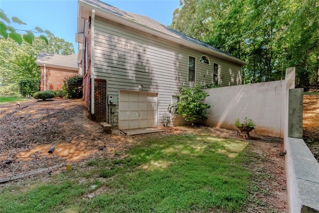 view of property exterior with a yard and a garage