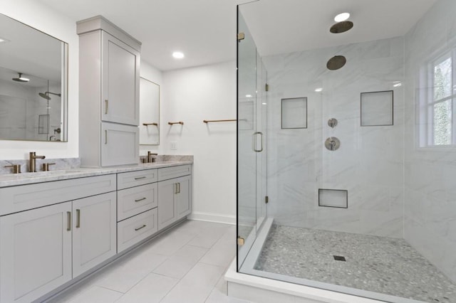 bathroom with vanity, a shower with shower door, and tile patterned flooring