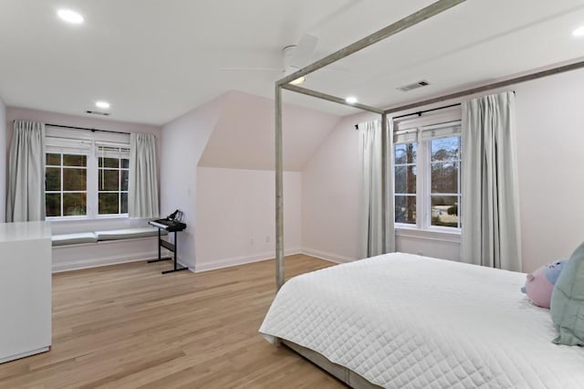 bedroom featuring ceiling fan, lofted ceiling, and light hardwood / wood-style flooring