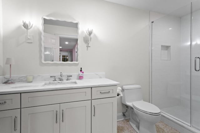 bathroom featuring vanity, toilet, a shower with door, and tile patterned flooring