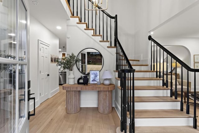 staircase with hardwood / wood-style flooring