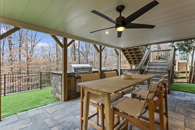 view of patio with ceiling fan, area for grilling, and grilling area