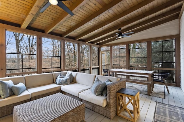 sunroom featuring ceiling fan, wooden ceiling, plenty of natural light, and vaulted ceiling with beams